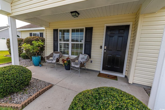 view of exterior entry featuring a patio area