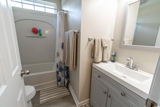 full bathroom with vanity, shower / tub combo, toilet, and hardwood / wood-style flooring