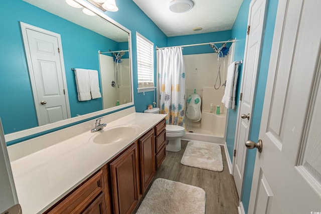 bathroom with a shower with curtain, vanity, hardwood / wood-style floors, and toilet