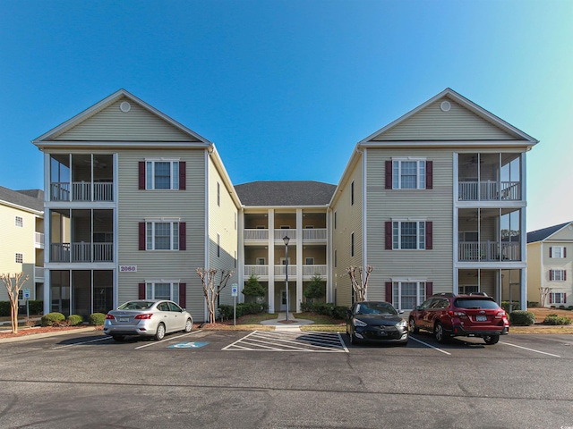 view of building exterior with uncovered parking