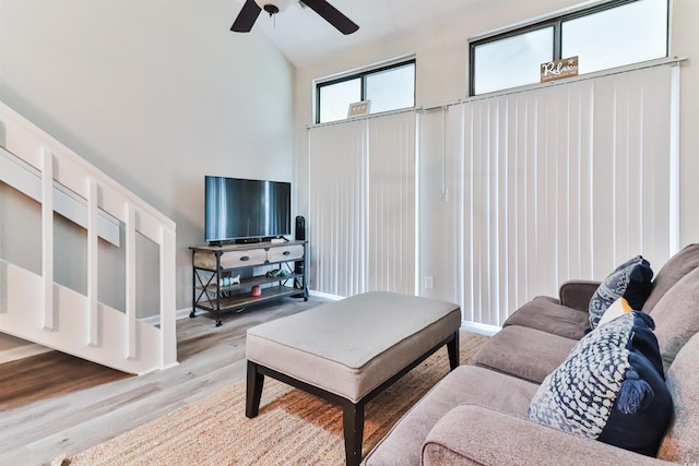 living room featuring ceiling fan, hardwood / wood-style flooring, and high vaulted ceiling