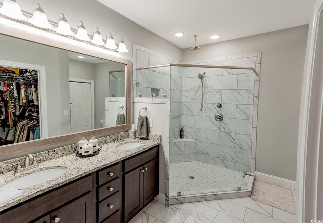 949 Jackline Pl Unit 103, Murrells Inlet, SC 29576 - full bath featuring double vanity, a shower stall, marble finish flooring, baseboards, and a walk in closet