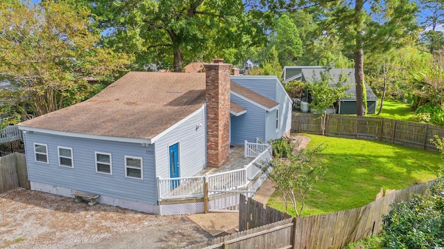 view of front of house with a front yard and a deck