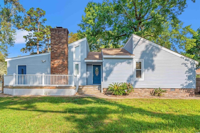 view of front of home with a deck and a front lawn