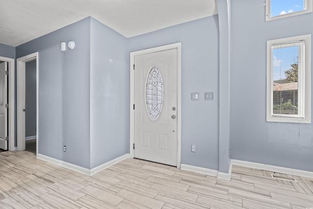 entrance foyer with light hardwood / wood-style floors and a wealth of natural light