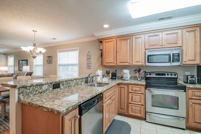 kitchen featuring ornamental molding, a peninsula, visible vents, stainless steel appliances, and a sink