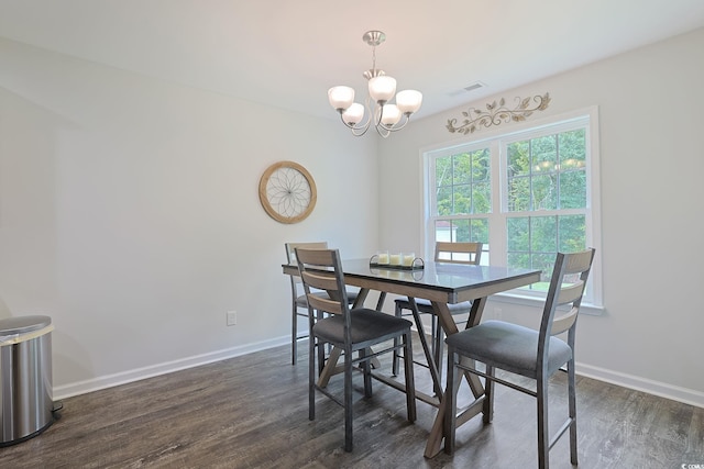 dining space featuring an inviting chandelier and dark hardwood / wood-style floors