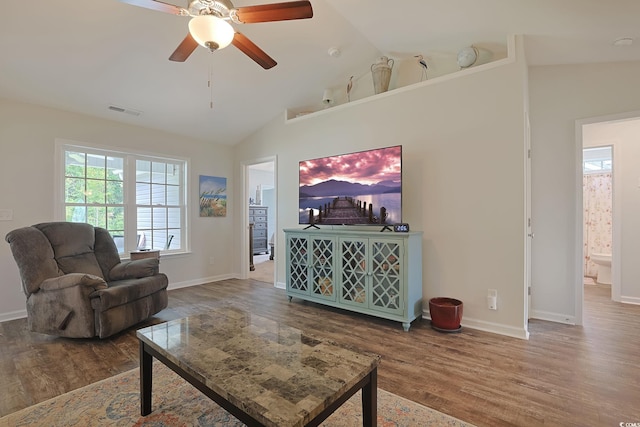 living room featuring wood-type flooring, lofted ceiling, and ceiling fan