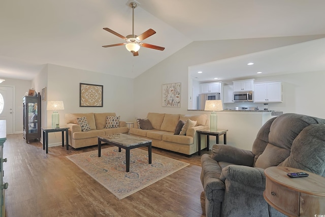 living room with ceiling fan, vaulted ceiling, and dark hardwood / wood-style flooring