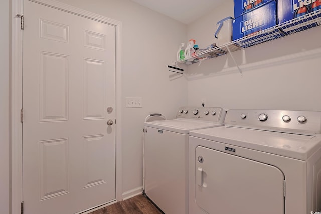 laundry area featuring washer and clothes dryer and dark hardwood / wood-style flooring