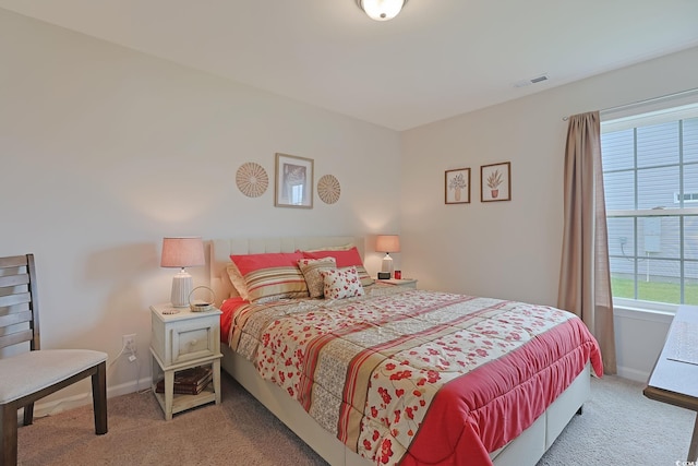 bedroom featuring carpet floors and multiple windows