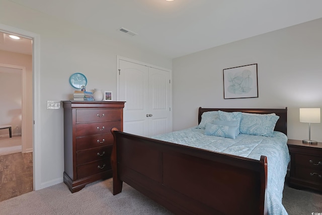 carpeted bedroom featuring a closet