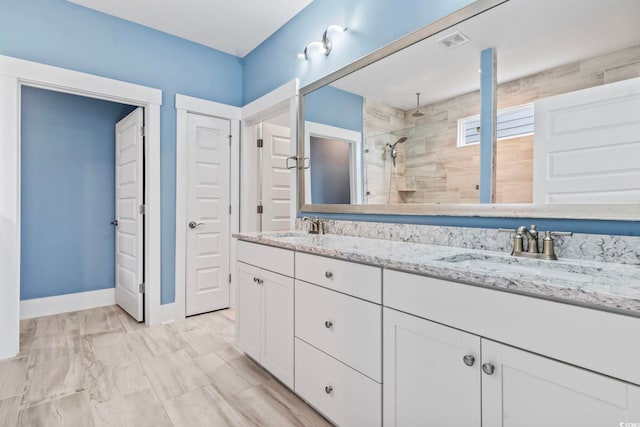 bathroom featuring vanity and tiled shower