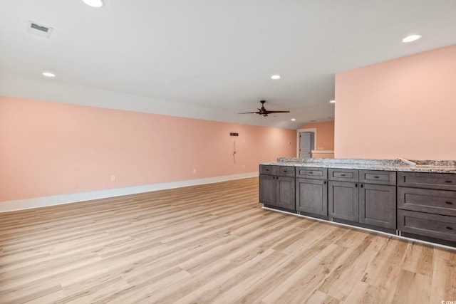 unfurnished living room with ceiling fan and light wood-type flooring