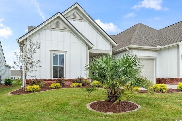 view of front of property with a front yard and a garage