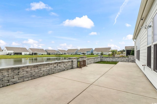 view of patio / terrace with a water view and a residential view