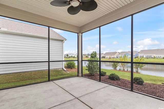 unfurnished sunroom with wooden ceiling, a water view, and ceiling fan