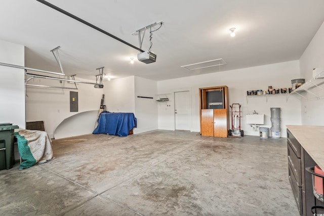 garage featuring a garage door opener, electric panel, and sink