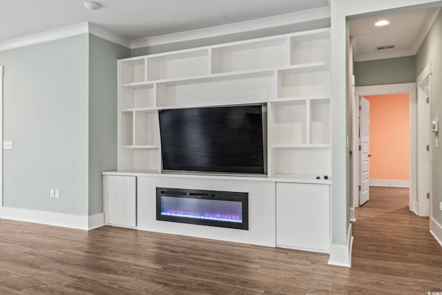 unfurnished living room with wood-type flooring and crown molding