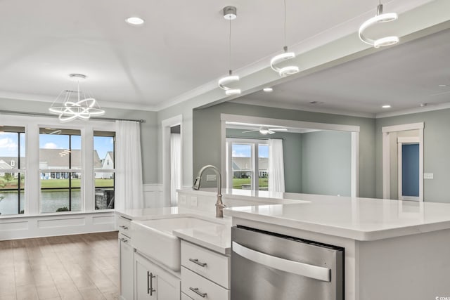 kitchen with a water view, decorative light fixtures, a healthy amount of sunlight, and stainless steel dishwasher