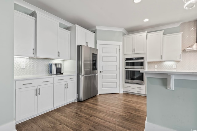 kitchen with backsplash, white cabinetry, dark hardwood / wood-style floors, and stainless steel appliances