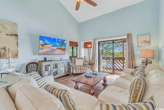 living room featuring light hardwood / wood-style floors, ceiling fan, and high vaulted ceiling