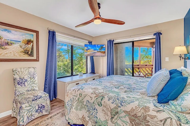 bedroom with wood-type flooring, ceiling fan, and access to exterior