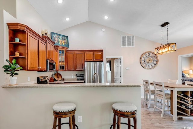 3154 Shorecrest Bay Dr, Murrells Inlet, SC 29576 - kitchen with a kitchen breakfast bar, open shelves, visible vents, a peninsula, and appliances with stainless steel finishes