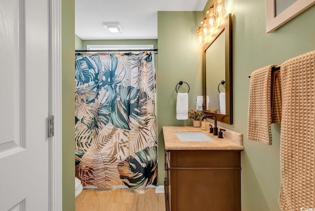 bathroom featuring vanity, toilet, and a shower with shower curtain