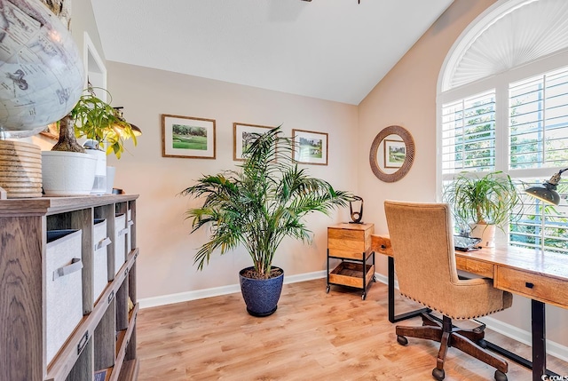 office space featuring light hardwood / wood-style flooring and vaulted ceiling