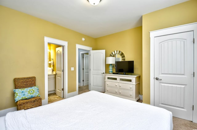 carpeted bedroom with ensuite bath