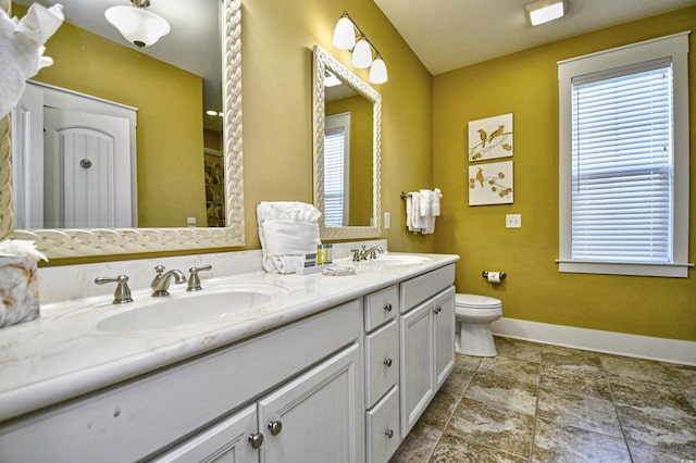 4808 Cantor Ct, North Myrtle Beach, SC 29582 - full bathroom featuring baseboards, double vanity, toilet, and stone finish flooring