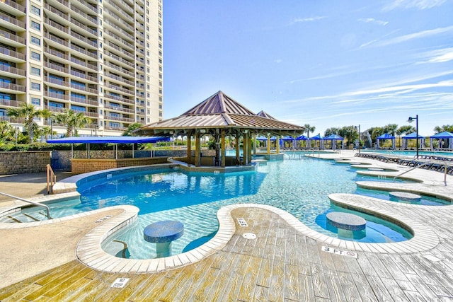 view of swimming pool with a hot tub, a patio area, and a gazebo