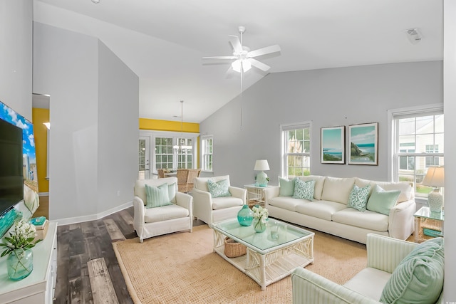 living room with hardwood / wood-style flooring, ceiling fan, and high vaulted ceiling