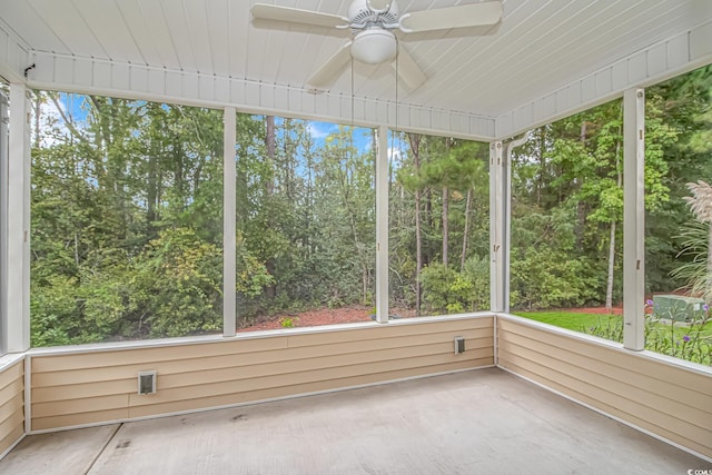 unfurnished sunroom featuring ceiling fan