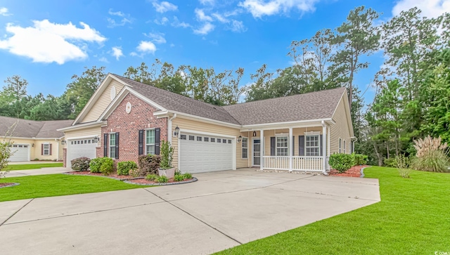 view of front of house featuring a front yard, a porch, and a garage