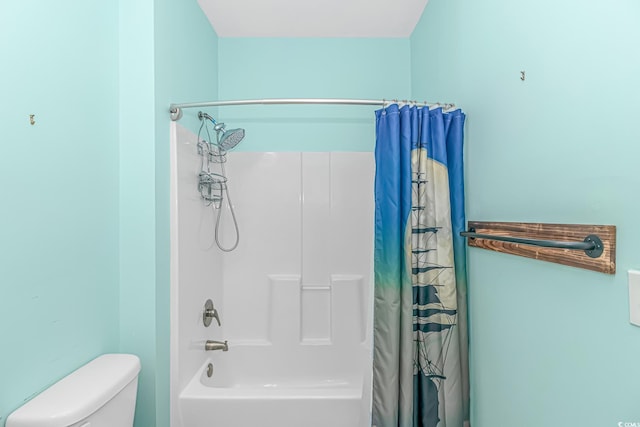 bathroom with shower / bathtub combination with curtain and toilet