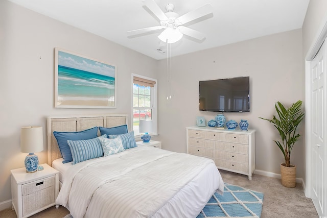 bedroom featuring light carpet, a closet, and ceiling fan