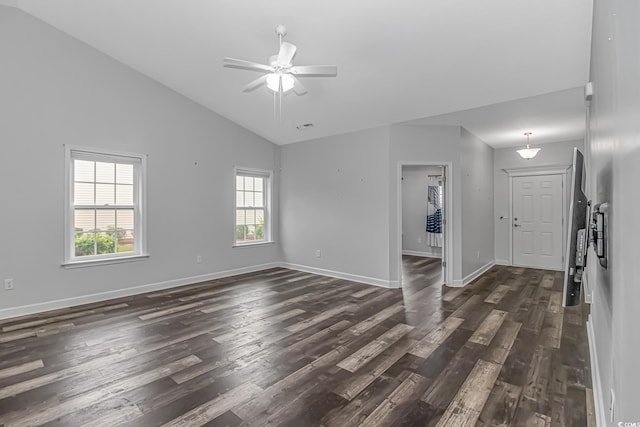 empty room featuring a wealth of natural light, dark hardwood / wood-style flooring, and ceiling fan