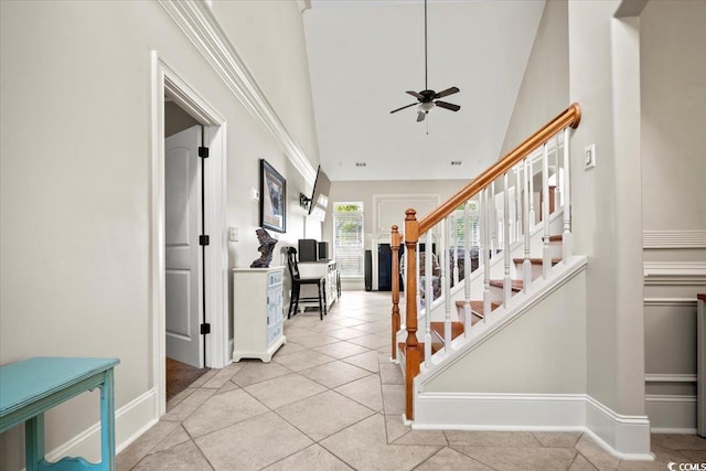 tiled foyer with ceiling fan and high vaulted ceiling