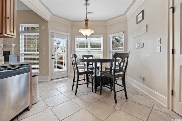 tiled dining area featuring ornamental molding