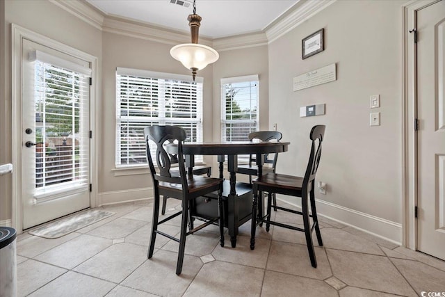 dining space featuring ornamental molding and light tile patterned floors