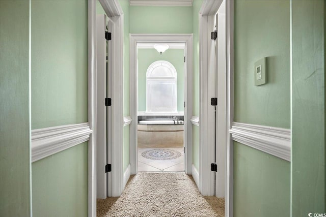 hall with light colored carpet