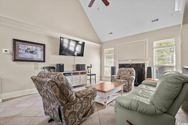 living room with a healthy amount of sunlight, light tile patterned floors, and ceiling fan