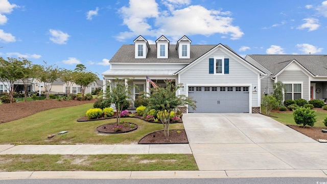 cape cod house with covered porch, a front yard, and a garage