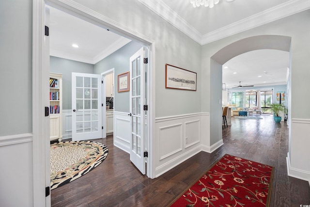 hall with ornamental molding, dark wood-type flooring, and french doors