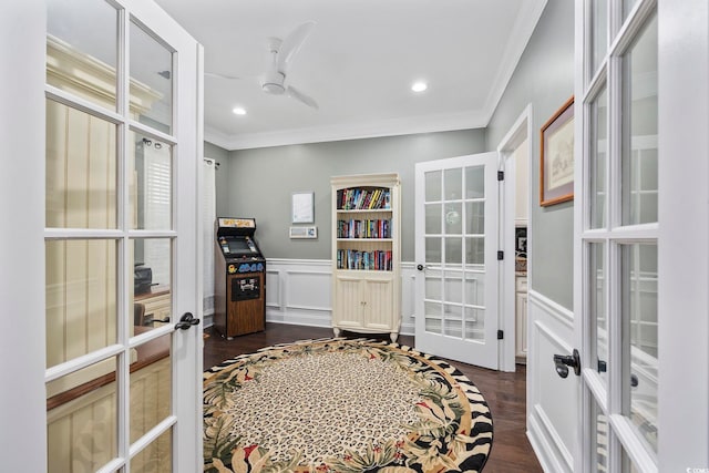 interior space with crown molding, dark hardwood / wood-style floors, ceiling fan, and french doors