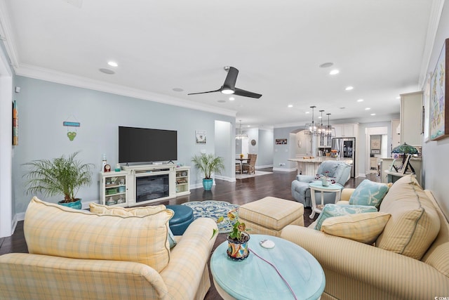 living room with hardwood / wood-style flooring, ceiling fan with notable chandelier, and ornamental molding