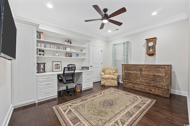 home office featuring ornamental molding, built in desk, ceiling fan, and dark hardwood / wood-style flooring