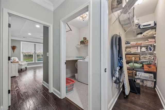 hall featuring washer / dryer, a raised ceiling, dark hardwood / wood-style floors, and crown molding